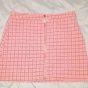Cute pink plaid mini skirt with gemed heart zipper, size small.